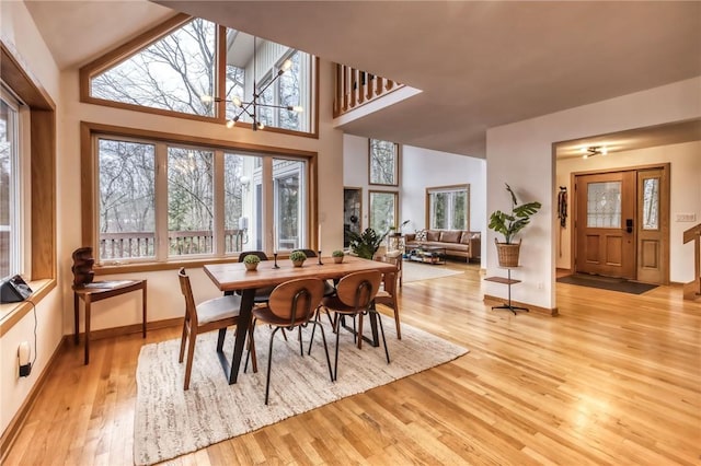 735 Howell Rd, Conquest, NY 13140 - dining space with light wood-type flooring, plenty of natural light, and a high ceiling