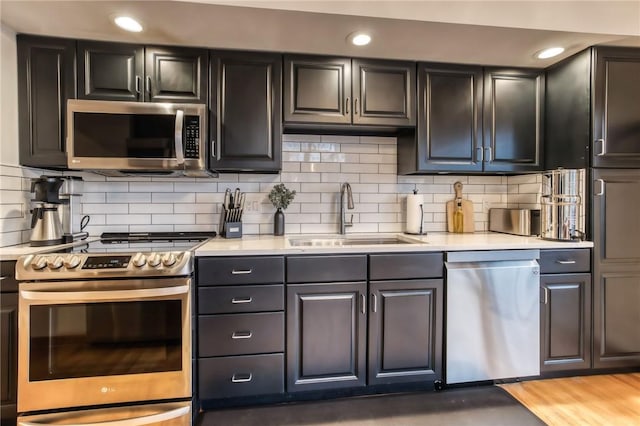 735 Howell Rd, Conquest, NY 13140 - kitchen featuring stainless steel appliances, light countertops, backsplash, and recessed lighting