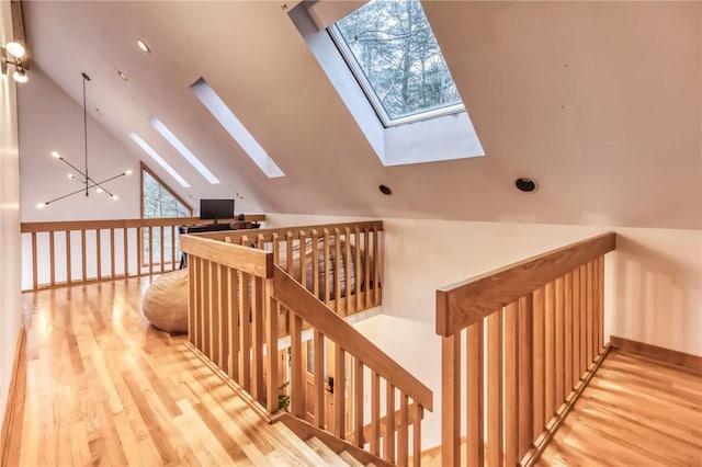 735 Howell Rd, Conquest, NY 13140 - staircase with a skylight, vaulted ceiling, wood finished floors, and recessed lighting