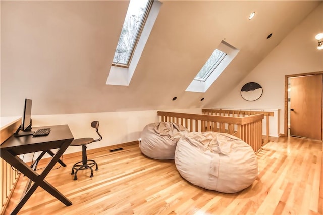 735 Howell Rd, Conquest, NY 13140 - living area with a skylight, wood finished floors, vaulted ceiling, and an office area
