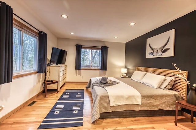 735 Howell Rd, Conquest, NY 13140 - bedroom with multiple windows, wood finished floors, and recessed lighting