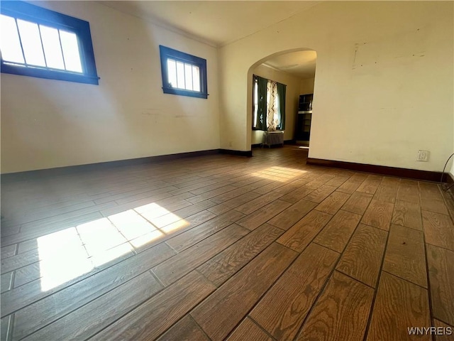 2010 Niagara St, Niagara Falls, NY 14303 - spare room featuring arched walkways and wood finished floors