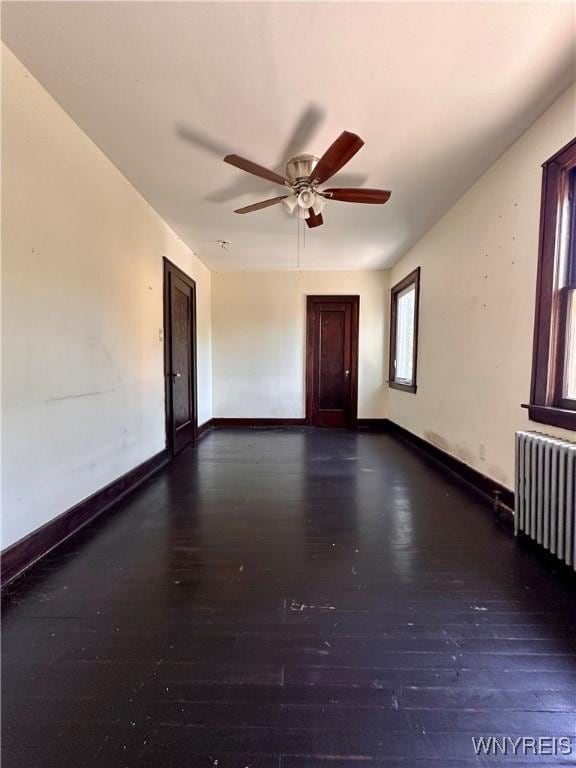 2010 Niagara St, Niagara Falls, NY 14303 - unfurnished room with radiator heating unit, hardwood / wood-style flooring, and ceiling fan