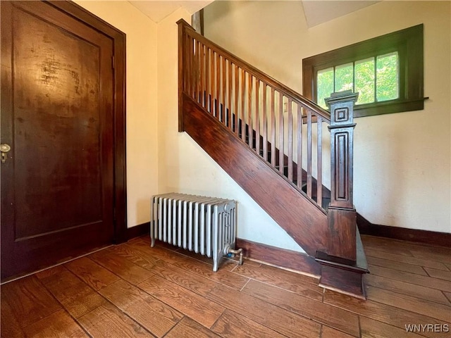 2010 Niagara St, Niagara Falls, NY 14303 - stairs featuring radiator heating unit and hardwood / wood-style floors