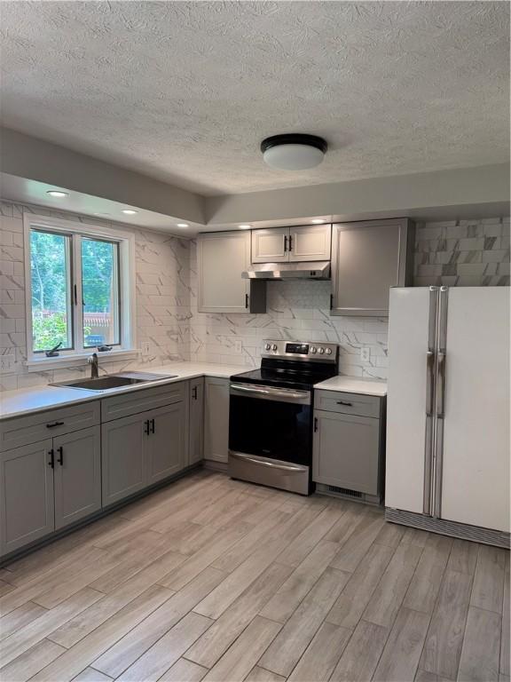 94 Brookhaven, Rochester, NY 14621 - kitchen featuring freestanding refrigerator, electric stove, gray cabinets, a textured ceiling, and light wood-style floors