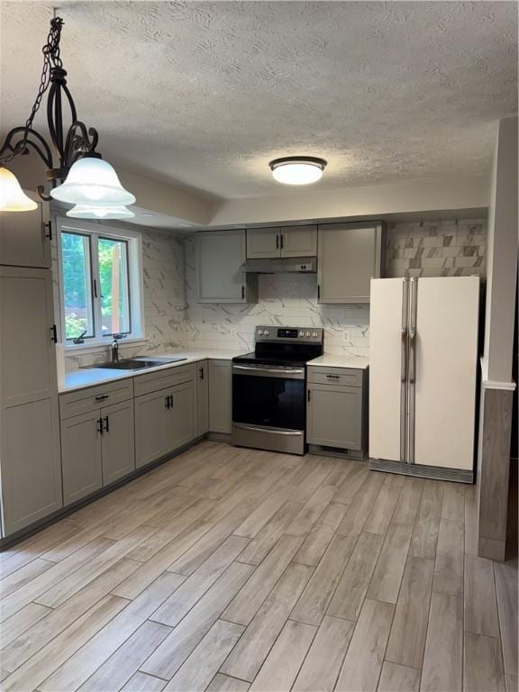 94 Brookhaven, Rochester, NY 14621 - kitchen featuring gray cabinets, stainless steel electric range, freestanding refrigerator, under cabinet range hood, and a textured ceiling