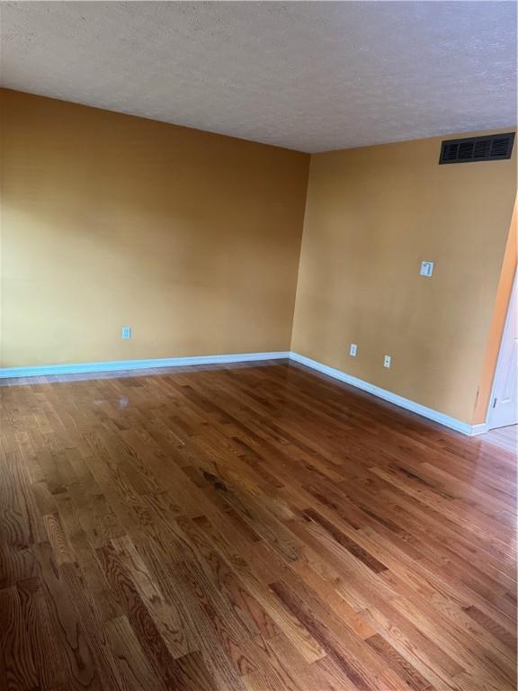 94 Brookhaven, Rochester, NY 14621 - unfurnished room featuring wood finished floors and a textured ceiling