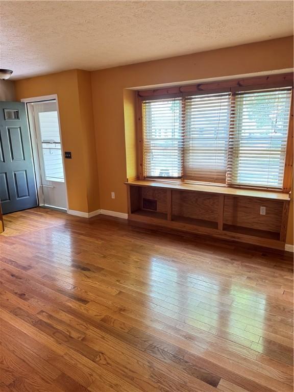 94 Brookhaven, Rochester, NY 14621 - empty room with a textured ceiling and wood finished floors