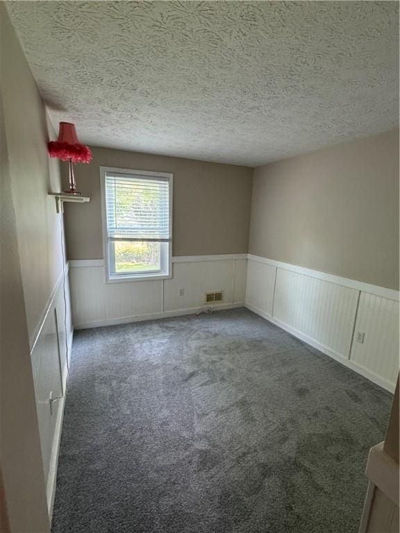 94 Brookhaven, Rochester, NY 14621 - spare room featuring a wainscoted wall, a textured ceiling, and carpet flooring