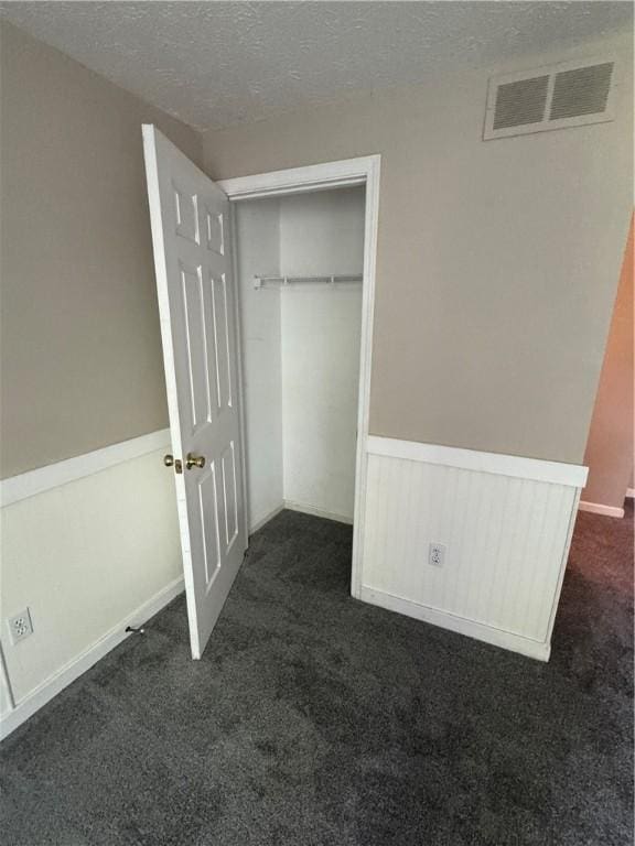 94 Brookhaven, Rochester, NY 14621 - unfurnished bedroom featuring dark carpet, a closet, and a textured ceiling