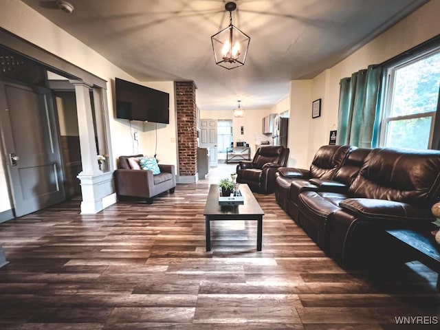 2218 Ferry Ave, Niagara Falls, NY 14301 - living area featuring dark wood finished floors, a chandelier, and decorative columns