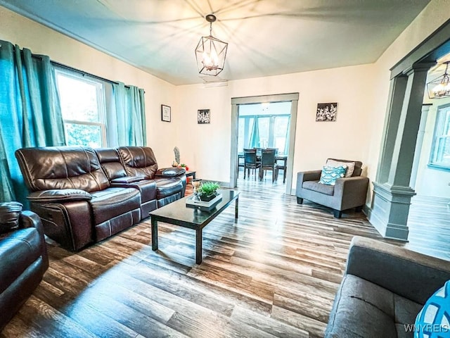 2218 Ferry Ave, Niagara Falls, NY 14301 - living room with wood finished floors, decorative columns, healthy amount of natural light, and a chandelier