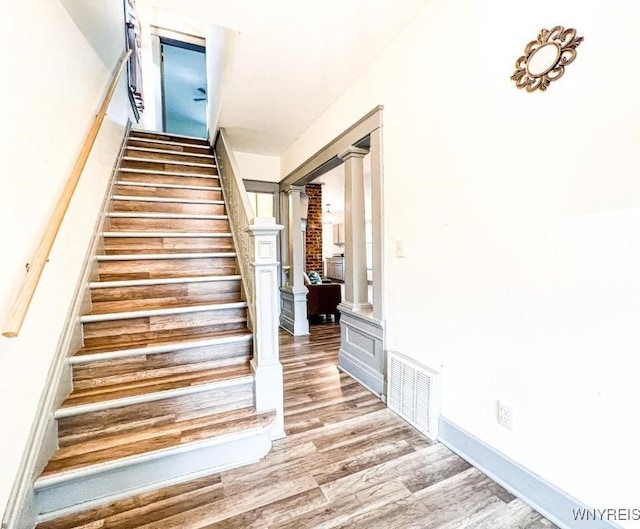 2218 Ferry Ave, Niagara Falls, NY 14301 - staircase with ornate columns and wood finished floors