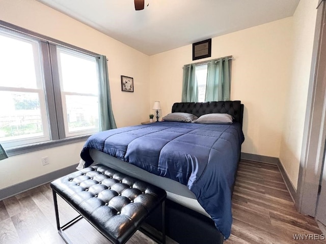 2218 Ferry Ave, Niagara Falls, NY 14301 - bedroom with multiple windows, wood finished floors, and a ceiling fan