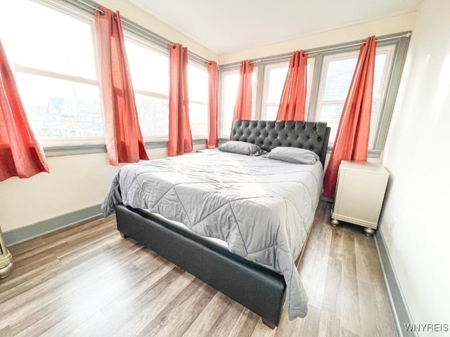 2218 Ferry Ave, Niagara Falls, NY 14301 - bedroom featuring wood finished floors and multiple windows