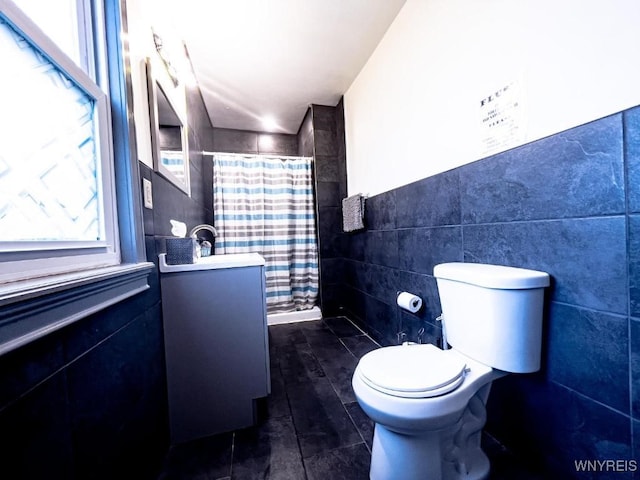2218 Ferry Ave, Niagara Falls, NY 14301 - bathroom with tile walls, vanity, and a shower with curtain