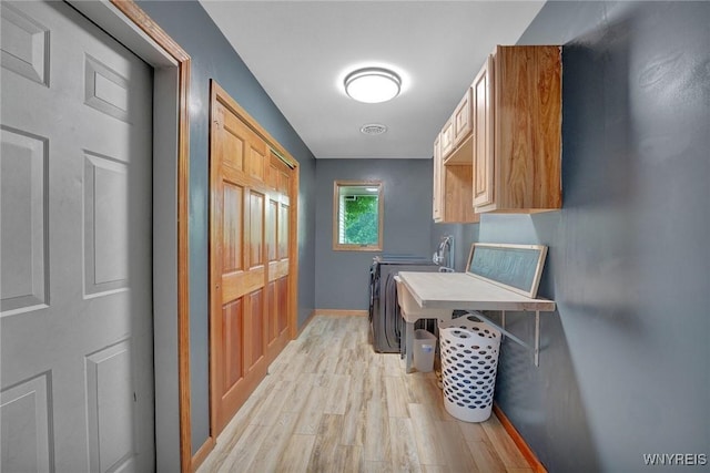 2328 Gowanda Zoar Rd, Collins, NY 14070 - laundry room with independent washer and dryer, light wood-type flooring, and cabinet space