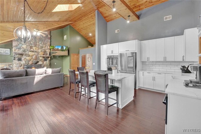 2328 Gowanda Zoar Rd, Collins, NY 14070 - kitchen with high vaulted ceiling, a wooden ceiling with exposed beams, a kitchen breakfast bar, stainless steel refrigerator, and open floor plan