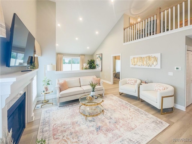 37C Stonham Pl, Amherst, NY 14221 - living area with high vaulted ceiling, light wood-type flooring, a fireplace, and recessed lighting