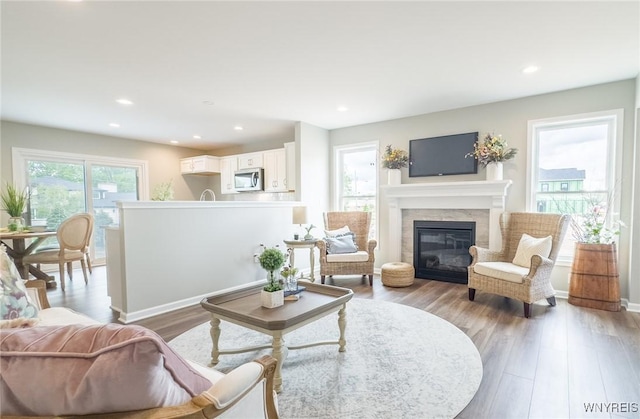 10 White Orchid Way, Lancaster, NY 14086 - living area with wood finished floors, a glass covered fireplace, and recessed lighting