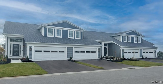 10 White Orchid Way, Lancaster, NY 14086 - view of front of property with driveway, a front lawn, a shingled roof, and a garage