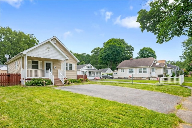 39 Castleford Rd, Greece, NY 14616 - view of front facade featuring a porch and asphalt driveway