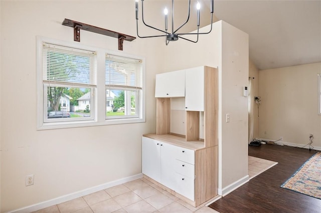 39 Castleford Rd, Greece, NY 14616 - unfurnished dining area featuring a chandelier, vaulted ceiling, and light wood-type flooring