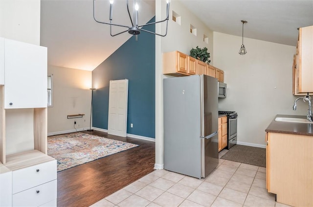 39 Castleford Rd, Greece, NY 14616 - kitchen with stainless steel appliances, light brown cabinetry, high vaulted ceiling, light wood finished floors, and decorative light fixtures