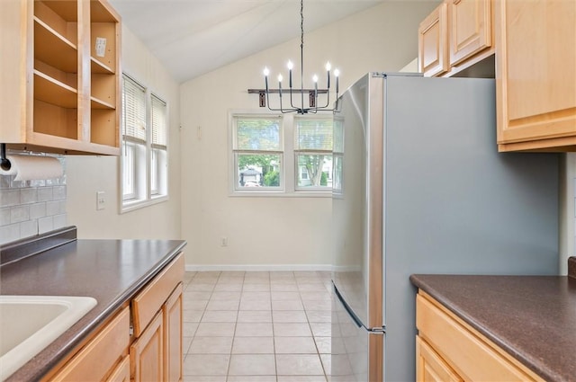 39 Castleford Rd, Greece, NY 14616 - kitchen featuring freestanding refrigerator, light brown cabinets, dark countertops, a chandelier, and vaulted ceiling