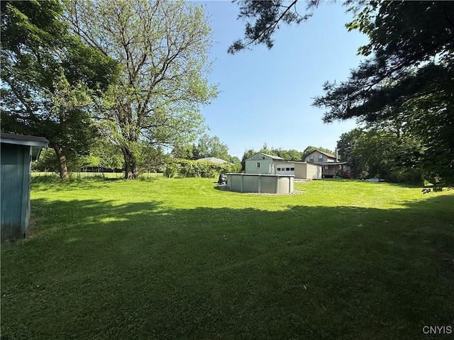 5130 Onondaga Rd, Onondaga, NY 13215 - view of grassy yard with an outdoor pool