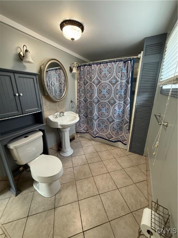 5130 Onondaga Rd, Onondaga, NY 13215 - full bath with tile patterned flooring, a shower with curtain, and ornamental molding
