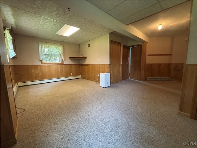 36 Lee Rd, Dryden, NY 13053 - below grade area with baseboard heating, a wainscoted wall, and wooden walls