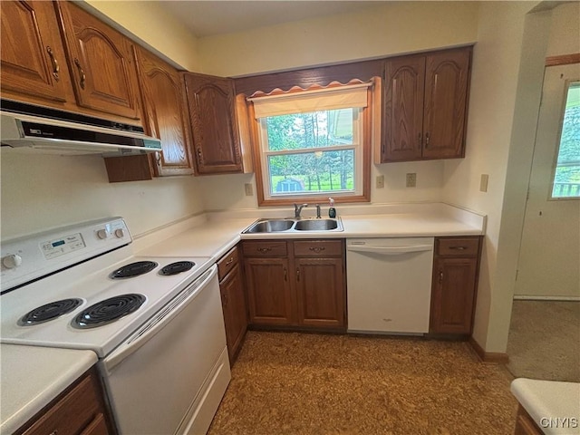 36 Lee Rd, Dryden, NY 13053 - kitchen with white appliances, under cabinet range hood, light countertops, and brown cabinetry