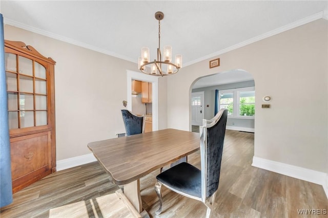 315 Westfield Rd N, Amherst, NY 14226 - dining room with arched walkways, wood finished floors, a chandelier, and ornamental molding
