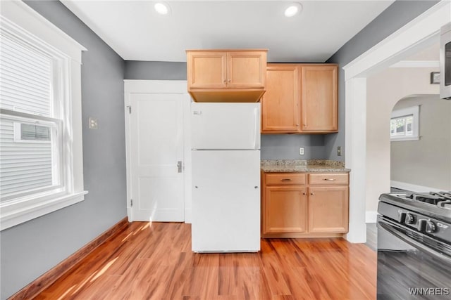 315 Westfield Rd N, Amherst, NY 14226 - kitchen featuring freestanding refrigerator, stainless steel range with gas cooktop, arched walkways, light wood finished floors, and recessed lighting