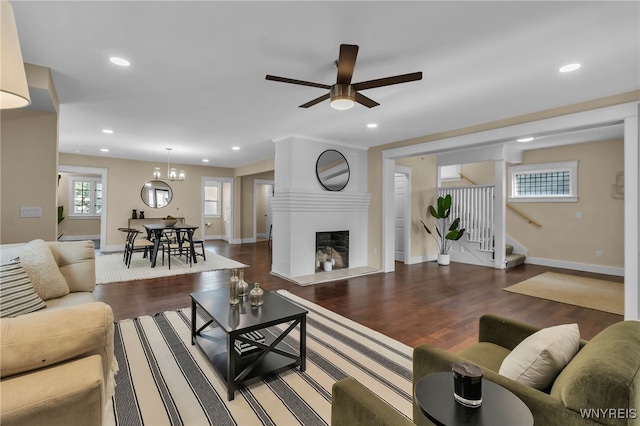 64 Sagamore Ter, Buffalo, NY 14214 - living room featuring stairway, recessed lighting, wood finished floors, a fireplace with raised hearth, and a ceiling fan