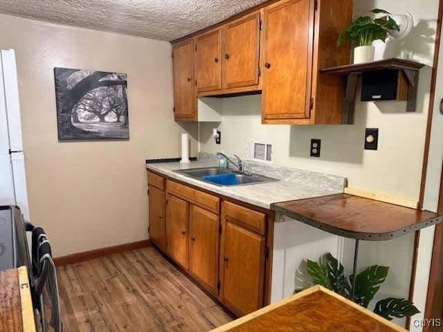 1086 Sweatman Ave, Oneida-Inside, NY 13421 - kitchen with stove, brown cabinetry, open shelves, light wood-style floors, and a textured ceiling