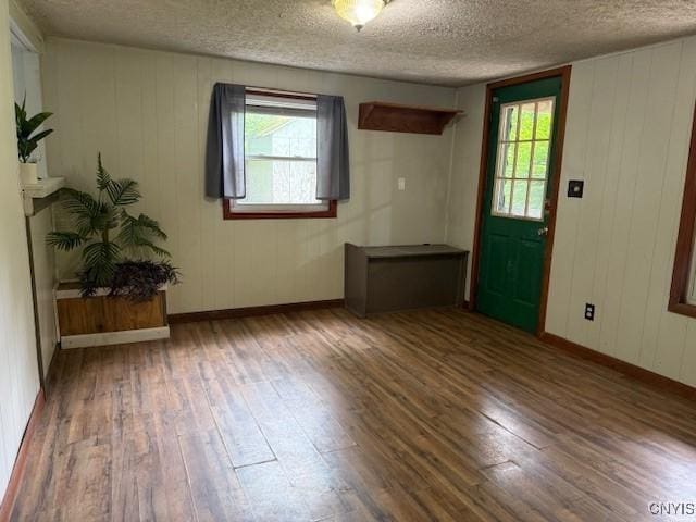 1086 Sweatman Ave, Oneida-Inside, NY 13421 - spare room featuring wood-type flooring, a textured ceiling, and wooden walls