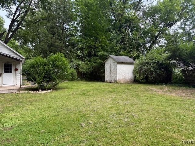 1086 Sweatman Ave, Oneida-Inside, NY 13421 - view of green lawn featuring a shed