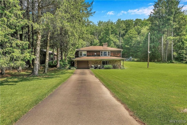 3738 Forks Rd, Yorkshire, NY 14134 - view of front facade with a garage, a chimney, asphalt driveway, a front yard, and a view of trees
