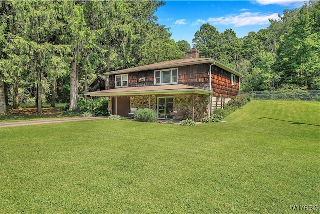 3738 Forks Rd, Yorkshire, NY 14134 - view of front of house featuring driveway, a chimney, a view of trees, a carport, and stone siding