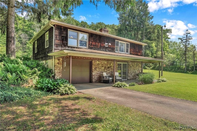 3738 Forks Rd, Yorkshire, NY 14134 - view of front of property with a garage, a front yard, a chimney, driveway, and stone siding