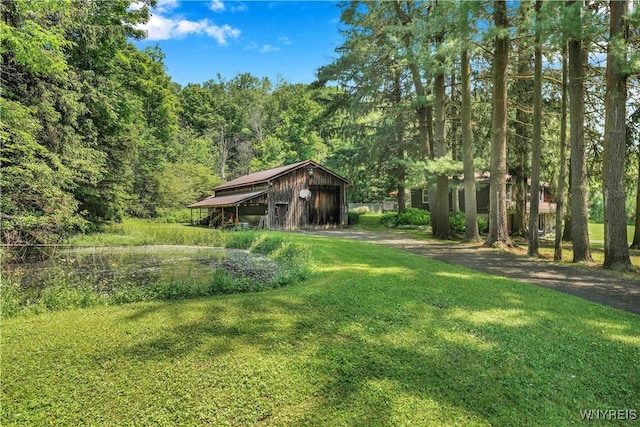 3738 Forks Rd, Yorkshire, NY 14134 - view of green lawn with a wooded view and an outdoor structure