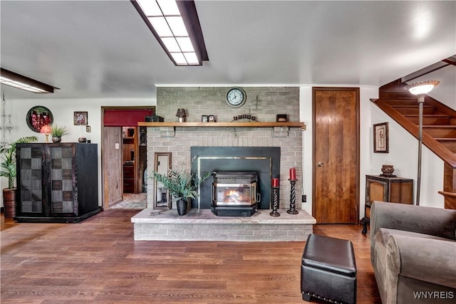 3738 Forks Rd, Yorkshire, NY 14134 - living room with wood finished floors, stairs, and a wood stove