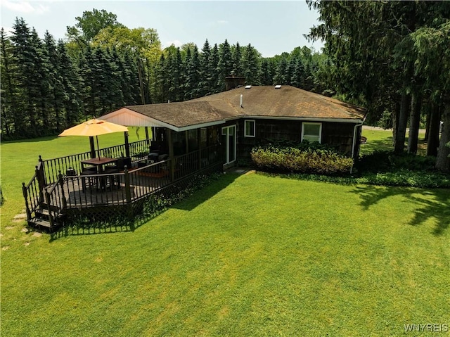 3738 Forks Rd, Yorkshire, NY 14134 - rear view of property featuring a chimney, a lawn, a wooden deck, and a view of trees