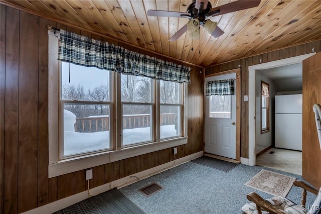 14328 Pearl St, Diana, NY 13648 - entryway with wood walls, wood ceiling, carpet, and a ceiling fan