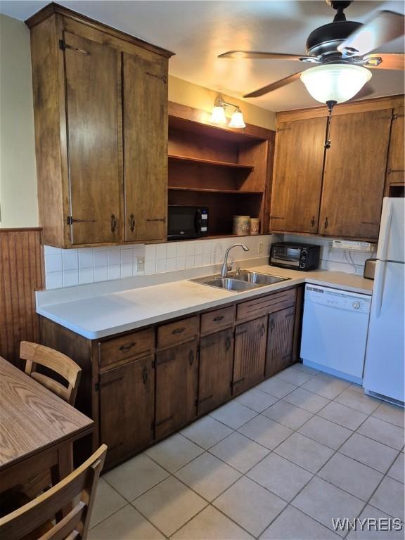 359 Utica St, Tonawanda-City, NY 14150 - kitchen with white appliances, open shelves, light countertops, light tile patterned floors, and a wainscoted wall