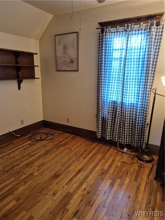359 Utica St, Tonawanda-City, NY 14150 - spare room with wood finished floors and vaulted ceiling