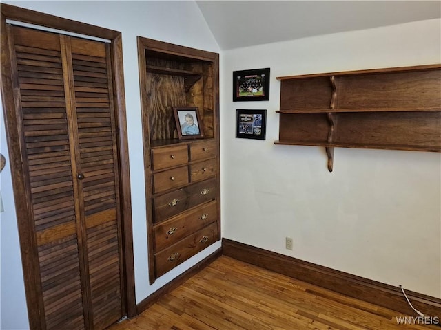 359 Utica St, Tonawanda-City, NY 14150 - unfurnished bedroom featuring wood finished floors and vaulted ceiling