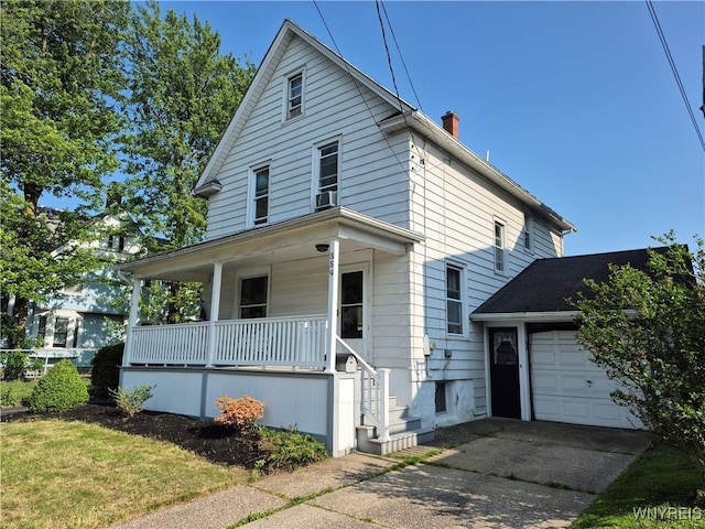 359 Utica St, Tonawanda-City, NY 14150 - american foursquare style home featuring covered porch, driveway, a chimney, and a garage